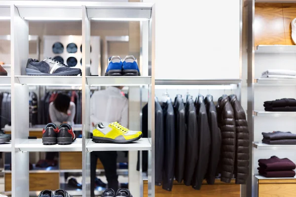 Men's clothes and shoes in modern shop — Stock Photo, Image