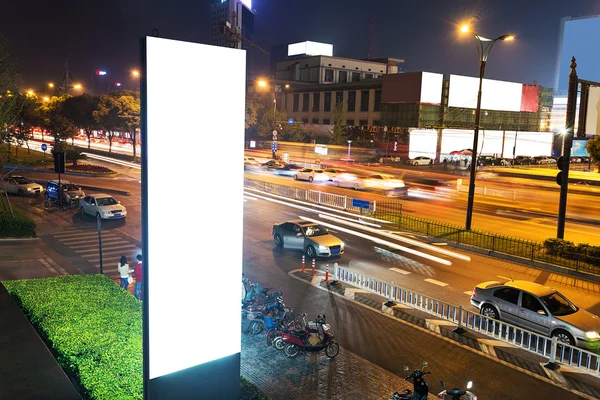 white display advertising with traffic at night