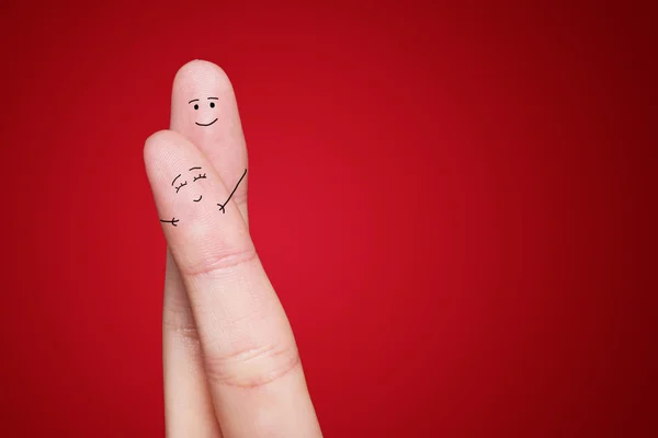 A happy couple in love with painted smiley and hugging — Stock Photo, Image