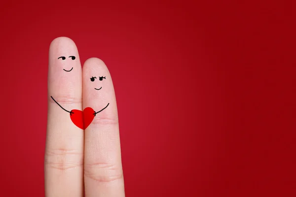 A happy couple in love with painted smiley and hugging — Stock Photo, Image