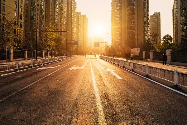 Road and buildings with sunset — Stock Photo, Image