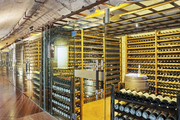 Wine cellar with wine bottle and glasses — Stock Photo, Image