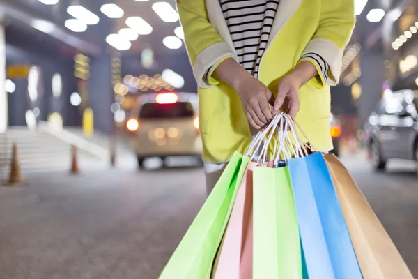 Happy woman shopping and holding bags girl — Stock Photo, Image