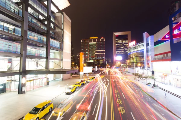 Car light trails and urban landscape in modern city — Stock Photo, Image