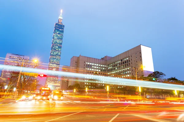 Car light trails and urban landscape in modern city — Stock Photo, Image