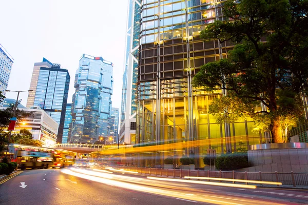 Modern buildings with vehicle trails of light on the street . — Stock Photo, Image