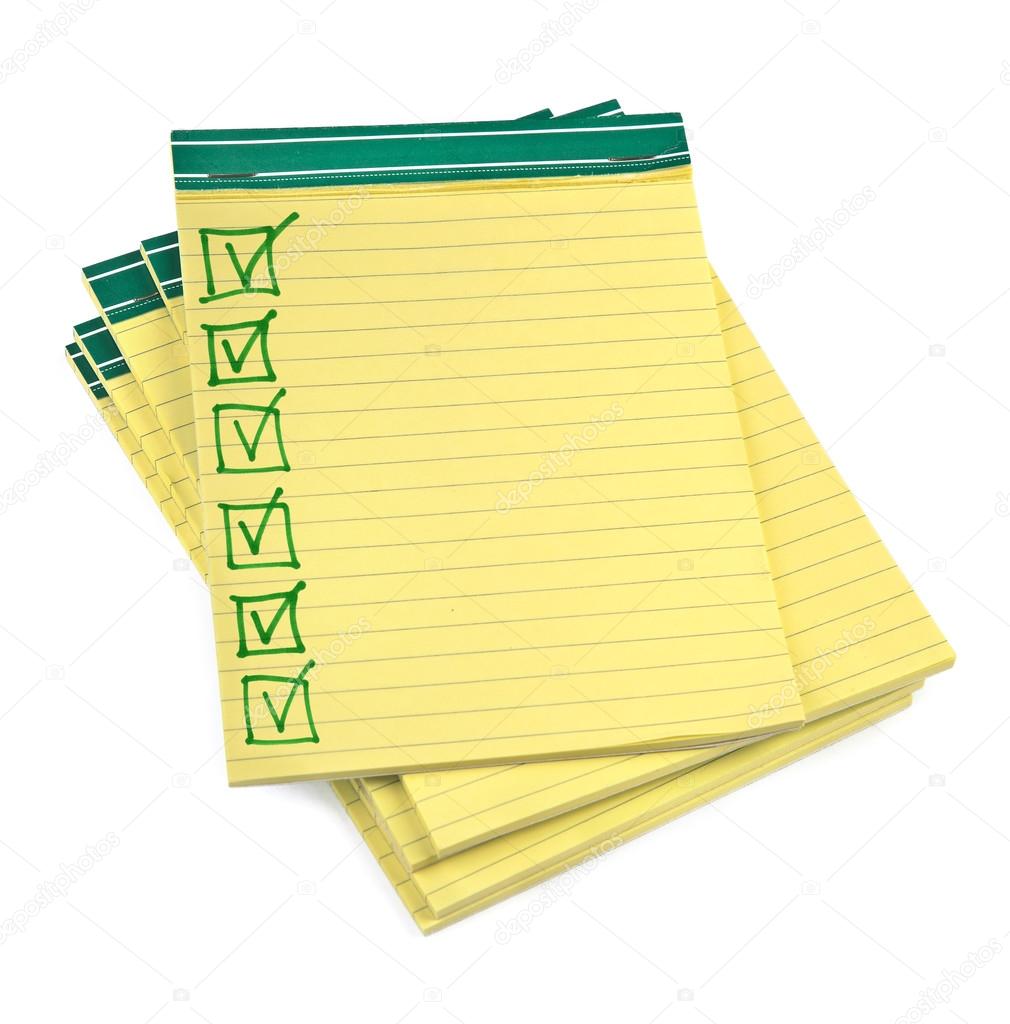 Lined paper notebooks with completed checklist