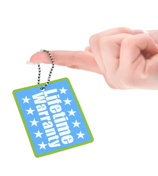 Female hand showing warranty tag — Stock Photo, Image