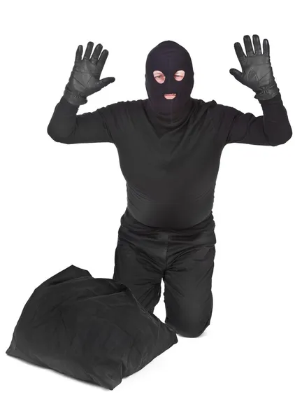 Bandit with sack surrendering over white — Stock Photo, Image