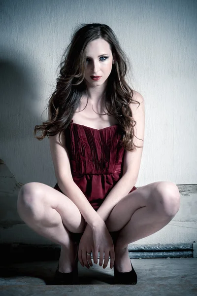 Fashion portrait of beautiful brunette woman in red dress — Stock Photo, Image