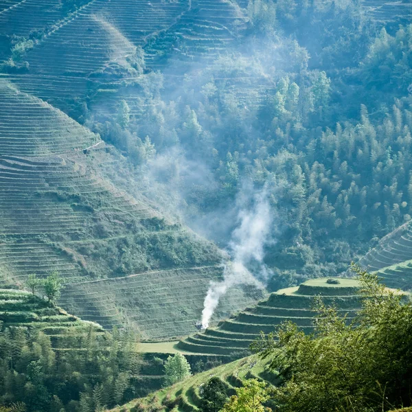 Green terraced field and smoke — Stock Photo, Image