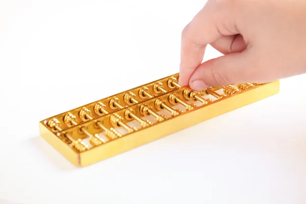 Golden abacus och en hand — Stockfoto