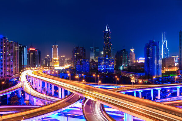 modern city skyline with interchange overpass at night