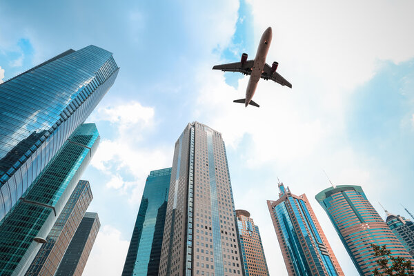 Upward view of modern building with airplane in shangha
