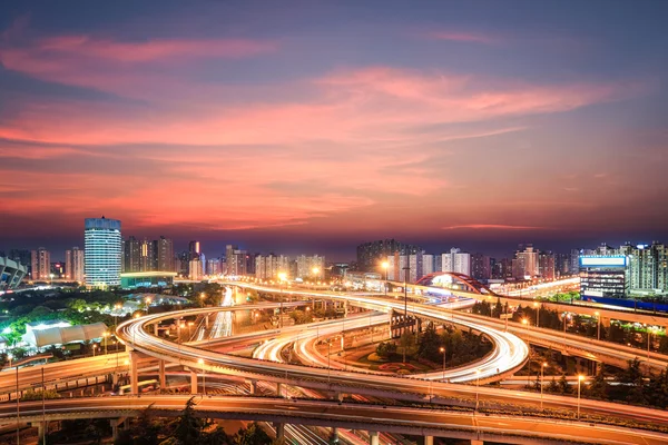 Modern city interchange in nightfall — Stock Photo, Image