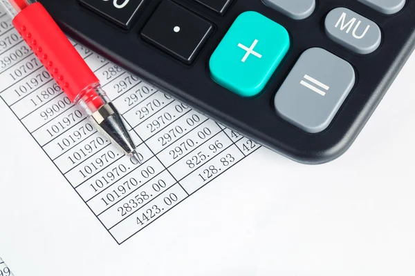 Calculator and red pen — Stock Photo, Image