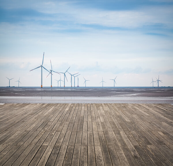 wind farm in mud flat with wooden floor