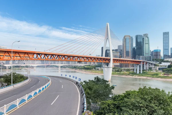 Chongqing cityscape against a blue sky, Qiansimen bridge on Jialing river with modern architecture in central business district, China