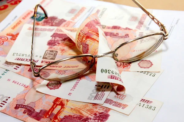 Heap soft money and old spectacles — Stock Photo, Image