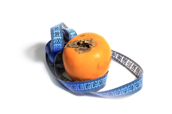 Measuring is a persimmon — Stock Photo, Image