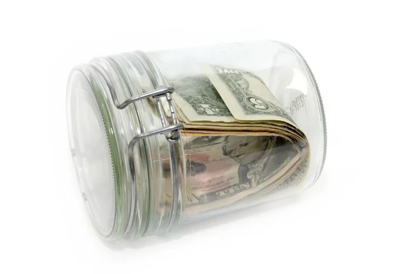 Доллары в стеклянном контейнере — стоковое фото