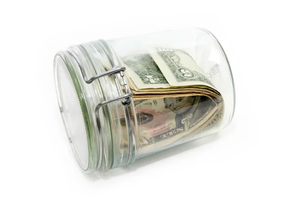 Доллары в стеклянном контейнере — стоковое фото
