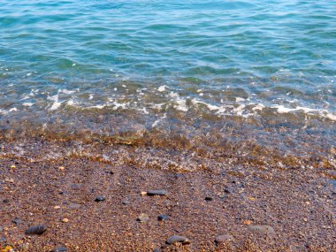 Şeffaf deniz dalgaları ve kumlu plajlar.