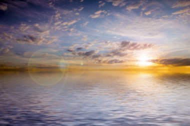 Sakin deniz suyu yüzeyindeki bulutlu gökyüzünün hoş yansıması