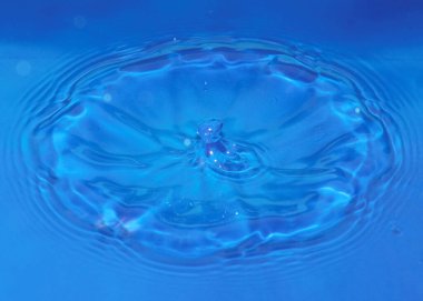 Düşerken bir damla saf saydam su sıvıda desenler oluşturur.