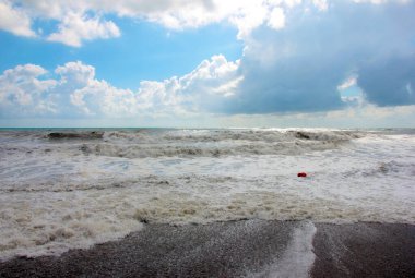 Deniz fırtınası sırasında dalgalar ve çakıl taşı plajı