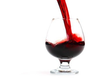 Bir shot bardağına dökerken kırmızı şarap girdapları