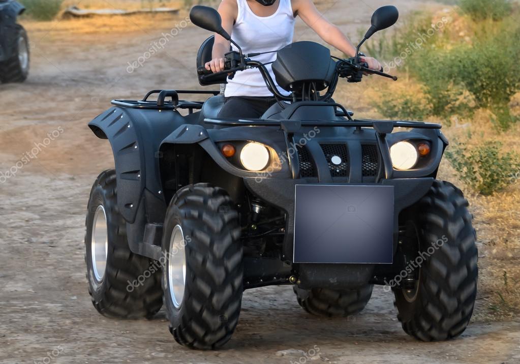Quad bike on a dirt road (all logos, inscriptions and markings removed)