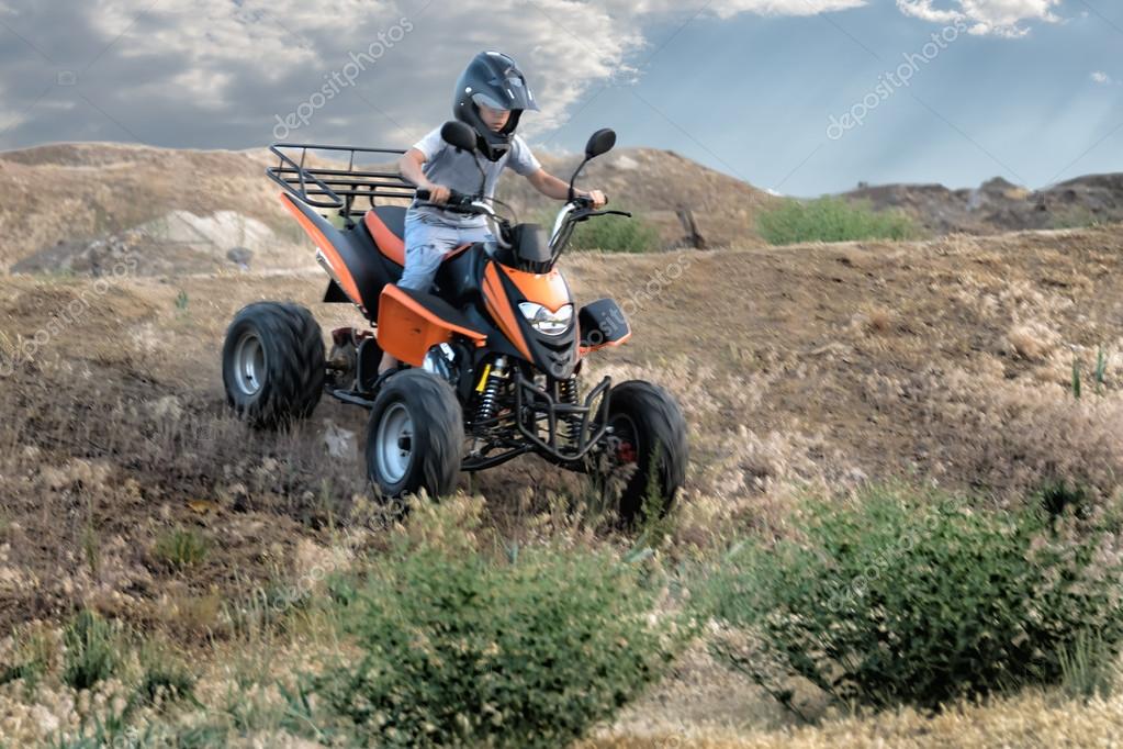 Quad bike on a dirt road (all logos, inscriptions and markings removed)