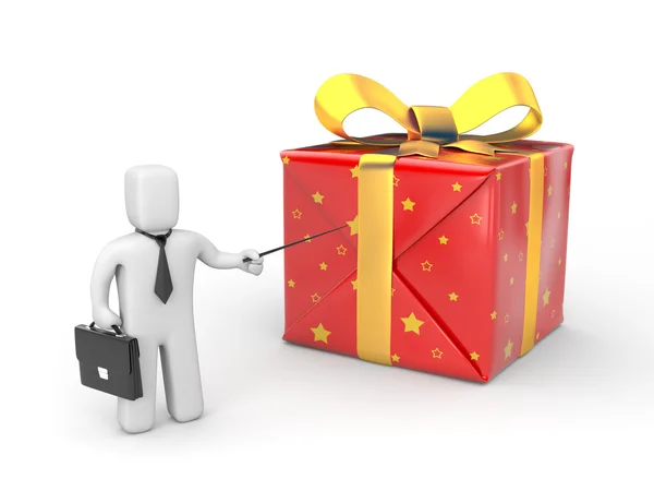 Businessman pointing to gift — Stock Photo, Image