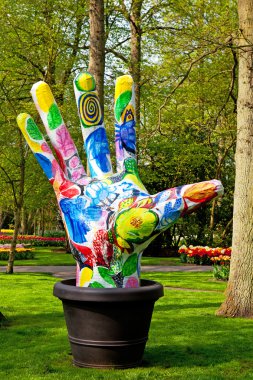 Colorful painted hand art in Keukenhof clipart