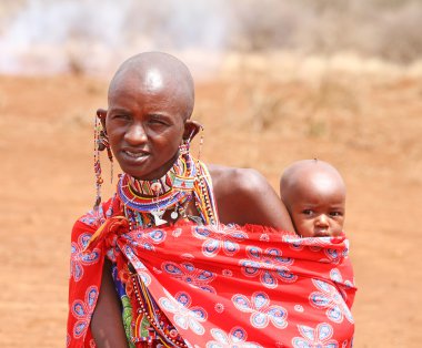 AFRICA, KENYA, MASAI MARA - JULY 2: Female tribal members wearin clipart