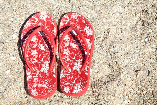 Red summer slippers on the beach Royalty Free Stock Images