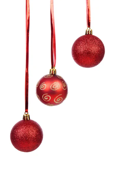 Three hanging Christmas balls on red ribbon over white backgroun — Stock Photo, Image