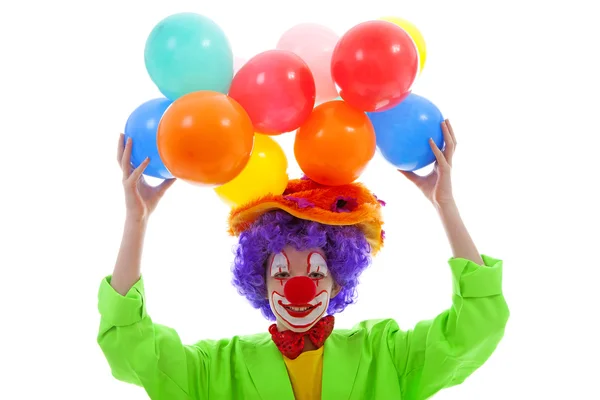 Kind gekleed als kleurrijke grappige clown met ballonnen Stockfoto