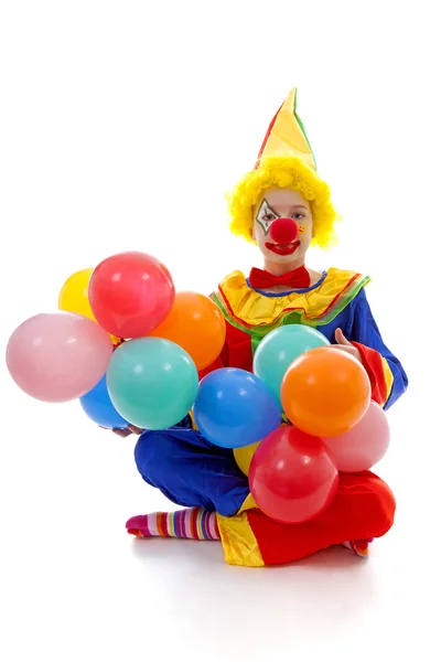 Ребенок, одетый как красочный смешной клоун с воздушными шарами Стоковое Фото