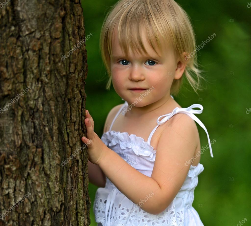 A little girl in a city park — Stock Photo © kyslynskyy #26656791