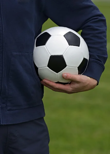 Pelota de fútbol en la mano —  Fotos de Stock