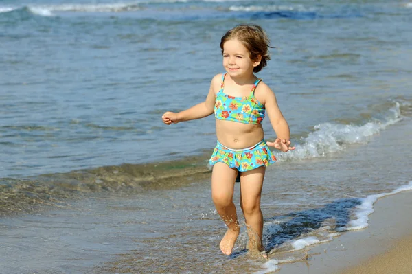 Happy toddler girl running at beach — Stock Photo, Image