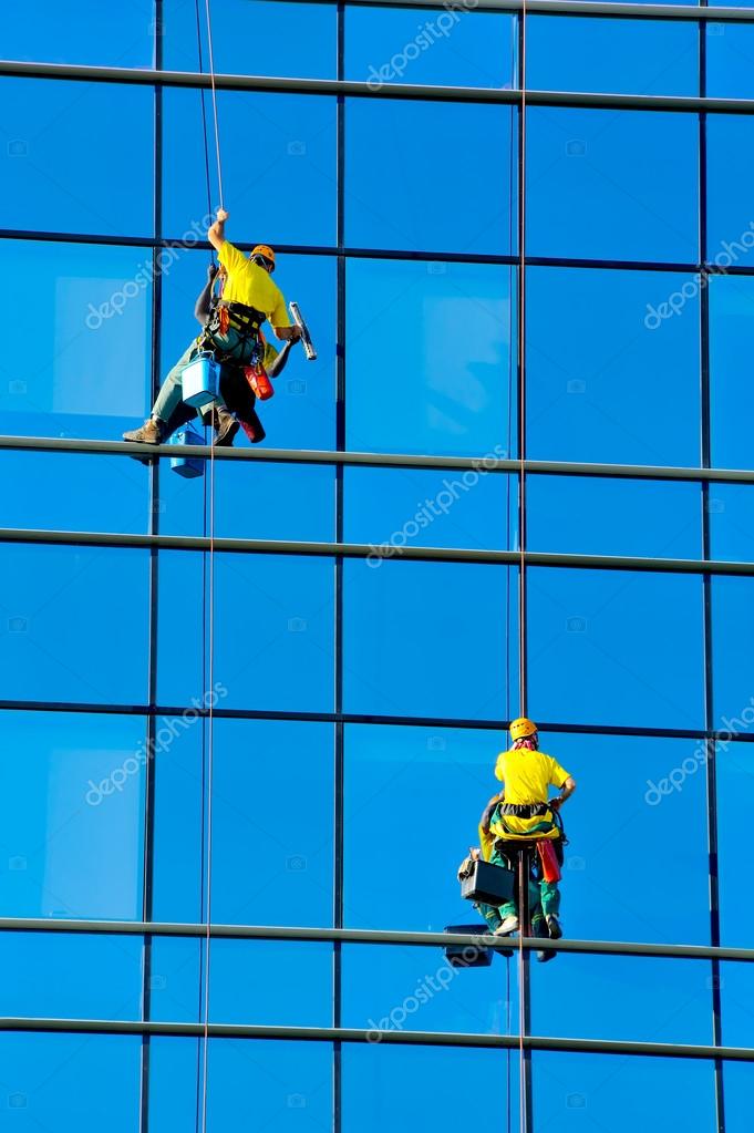 Washers wash the windows of modern skyscraper Stock Photo by ©pajche