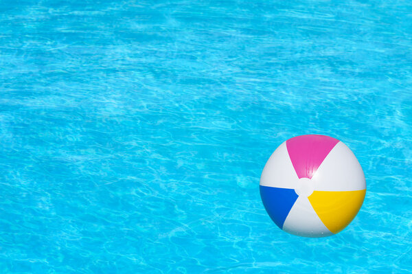 Inflatable ball floating in swimming pool