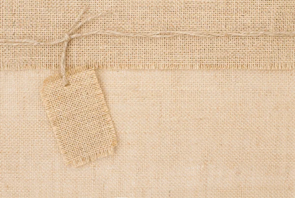 Sackcloth tag pricing over burlap texture — Stockfoto