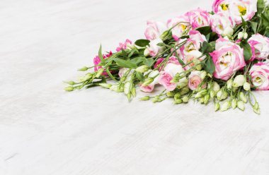 Lisianthuses flower bouquet lying on white floor clipart