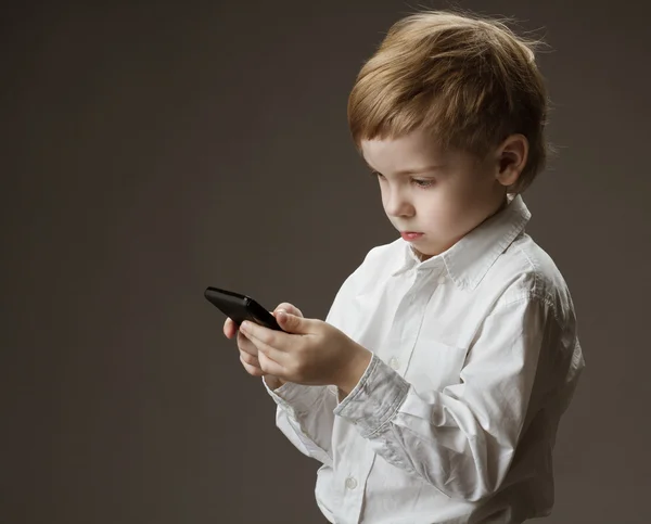 Boy playing game on cell phone. Kid holding mobile — Stock Photo, Image