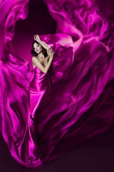 Woman in violet waving silk dress. Dancing. — Stock Photo, Image