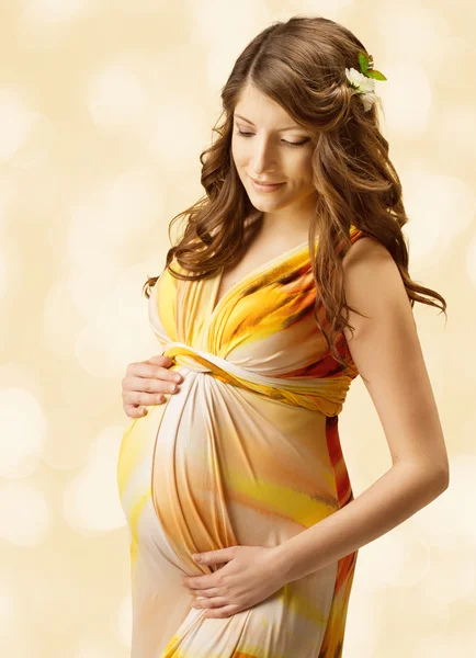 Pregnant woman over yellow art background. — Stock Photo, Image